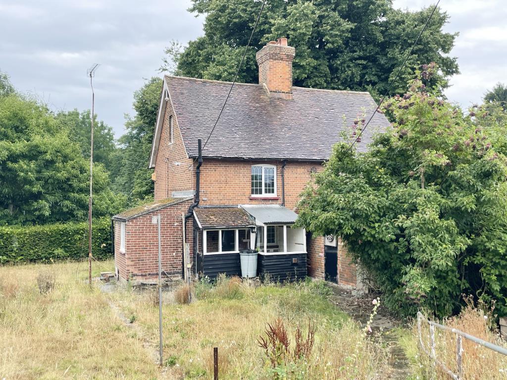 Lot: 138 - RURAL SEMI-DETACHED COTTAGE FOR IMPROVEMENT ON LARGE PLOT - View to front of rural semi in need of refurbishment